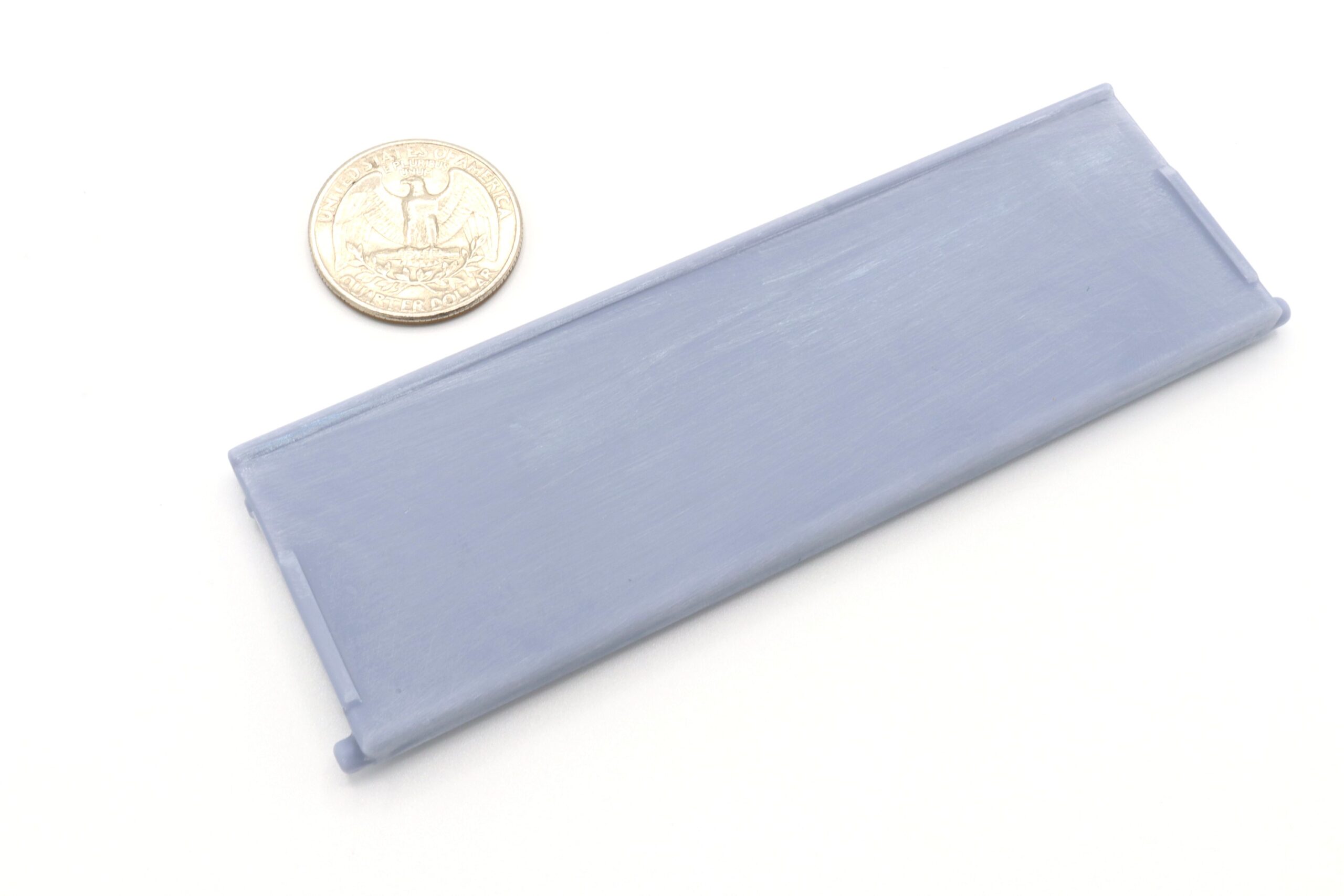 Rectangular battery beside a coin for scale.